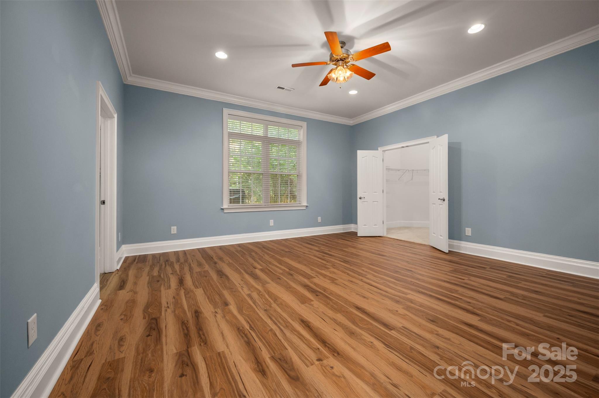 288 Palms Way Forest City, NC 28043 - Photo 37 of 47 an empty room with wooden floor and windows