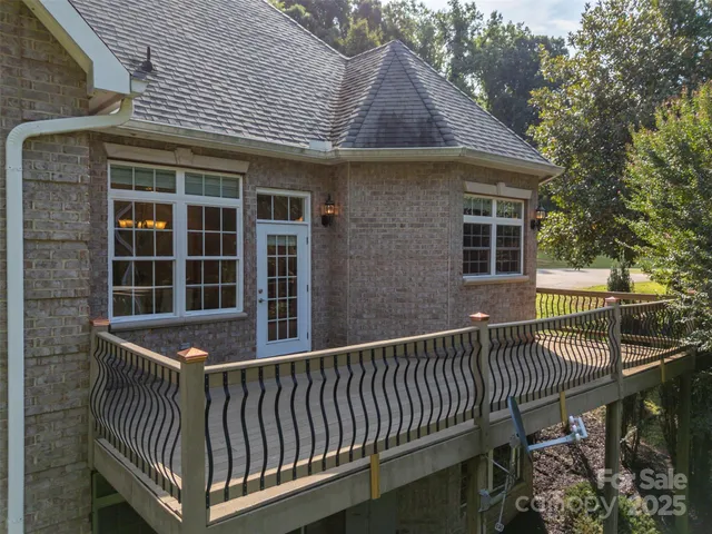 a view of a roof deck with wooden fence and floor