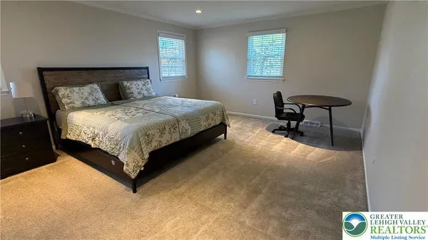 a bedroom with a bed chair and window