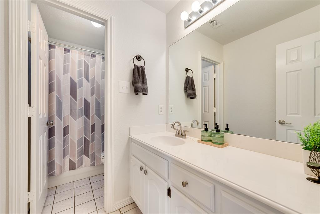 106 Villanova Circle Forney, TX 75126 - Photo 21 of 26 a bathroom with a sink and a mirror