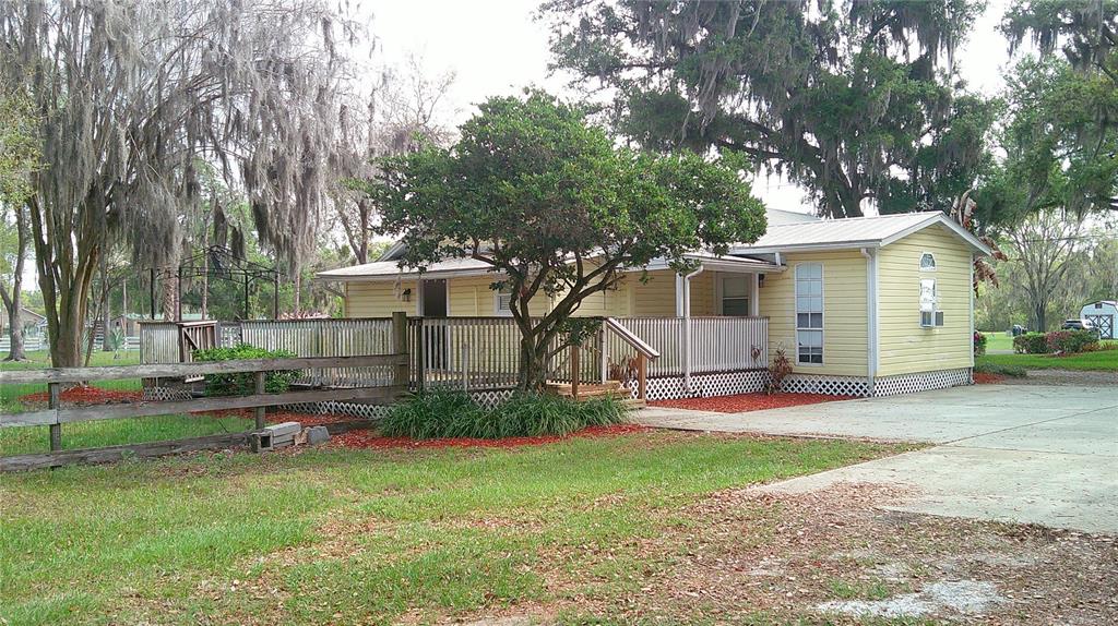 4609 Gallagher Road Plant City, FL 33565 - Photo 4 of 23 a view of backyard of house with wooden deck and seating space