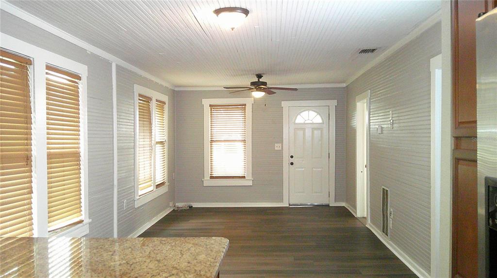 4609 Gallagher Road Plant City, FL 33565 - Photo 5 of 23 a view of an empty room with wooden floor and a window