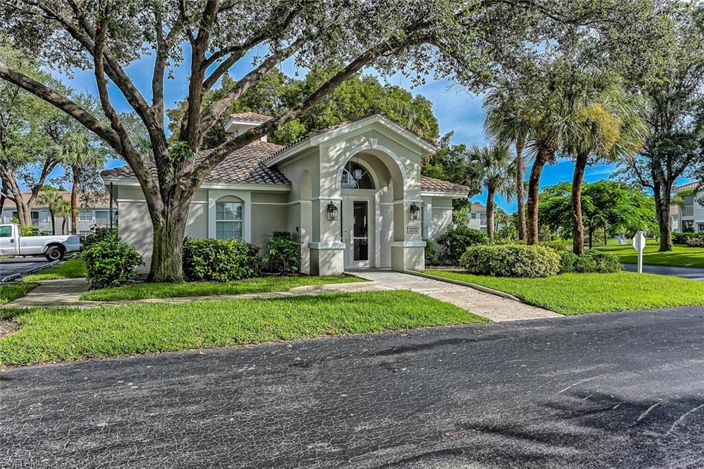 6910 Satinleaf Road North, Unit 101 Naples, FL 34109 - Photo 28 of 30 Mediterranean / spanish-style home with a front lawn