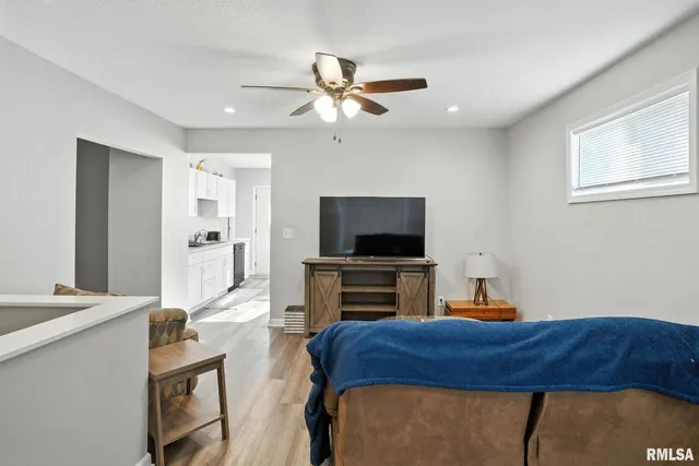 a bedroom with furniture and a flat screen tv