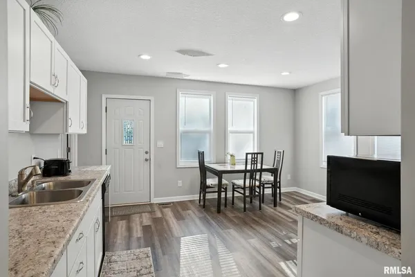 a view of a dining room with furniture and a flat screen tv
