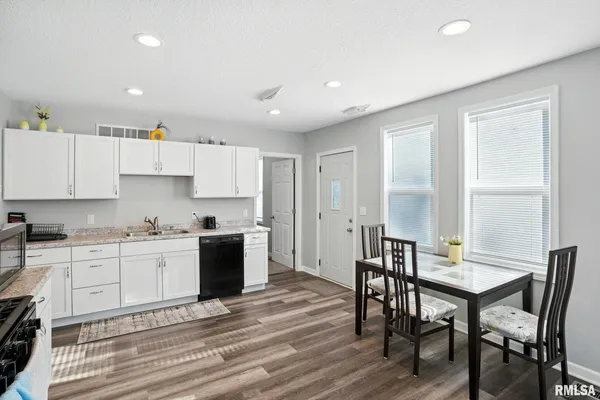 a kitchen with a table and chairs in it