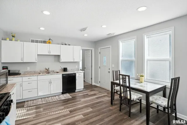 a kitchen with a table and chairs in it