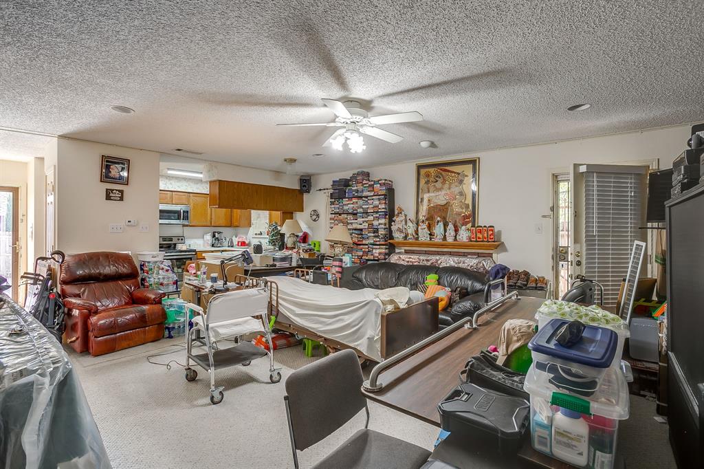 3133 Sappington Place, Unit D Fort Worth, TX 76116 - Photo 14 of 28 a living room with furniture gym equipment and a large window