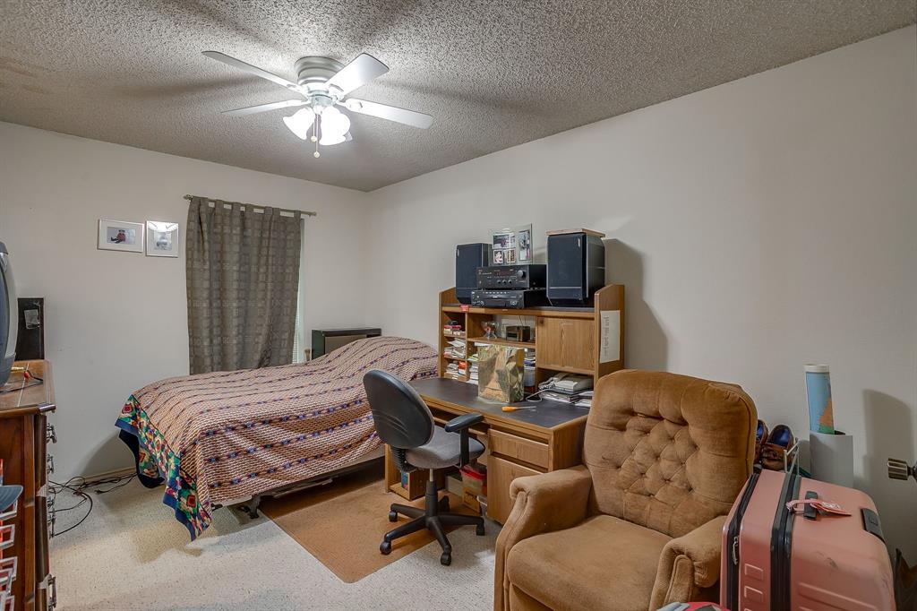 3133 Sappington Place, Unit D Fort Worth, TX 76116 - Photo 17 of 28 a bedroom with a bed and a chandelier