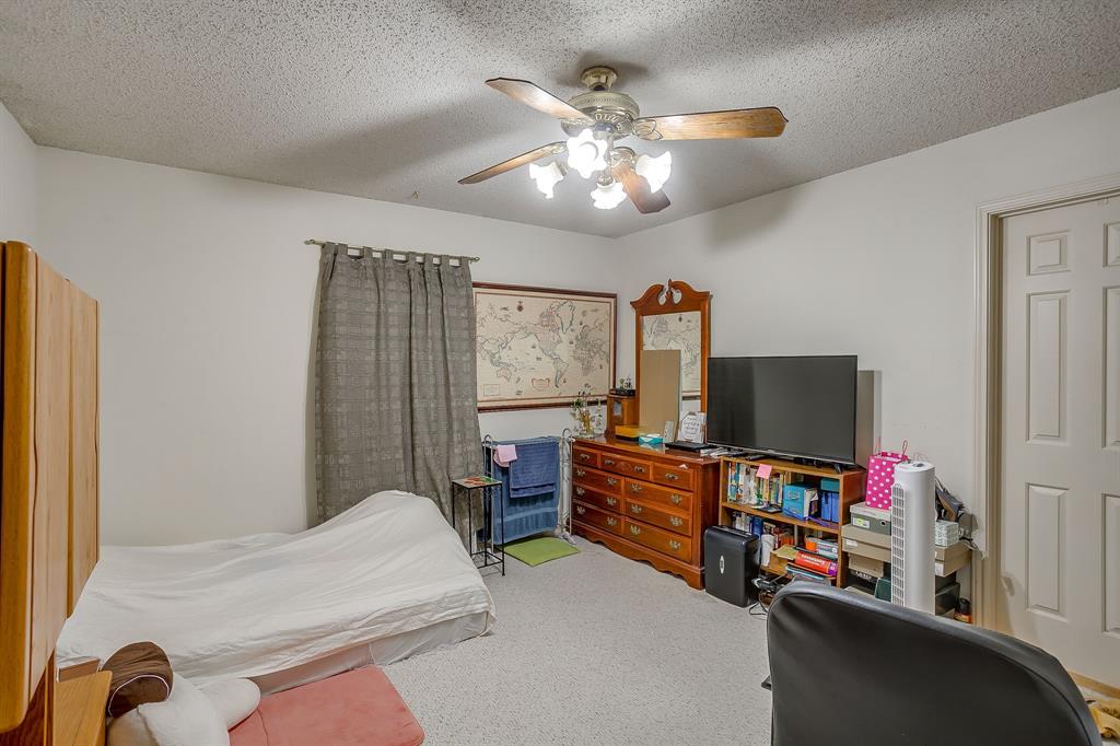3133 Sappington Place, Unit D Fort Worth, TX 76116 - Photo 21 of 28 a bedroom with furniture and a flat screen tv