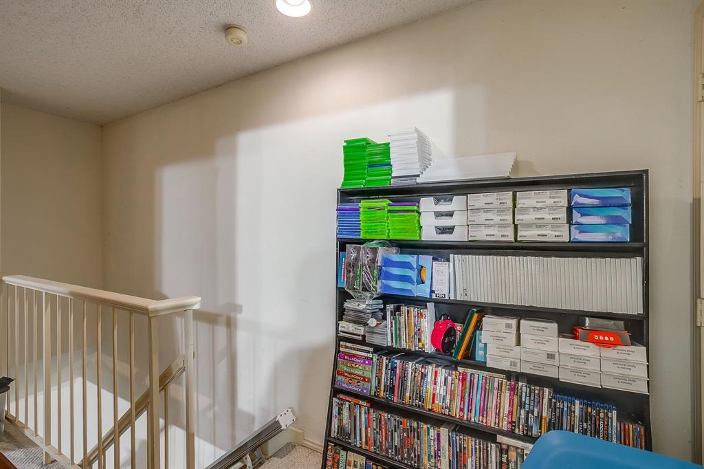 3133 Sappington Place, Unit D Fort Worth, TX 76116 - Photo 23 of 28 a room with furniture and a book shelf