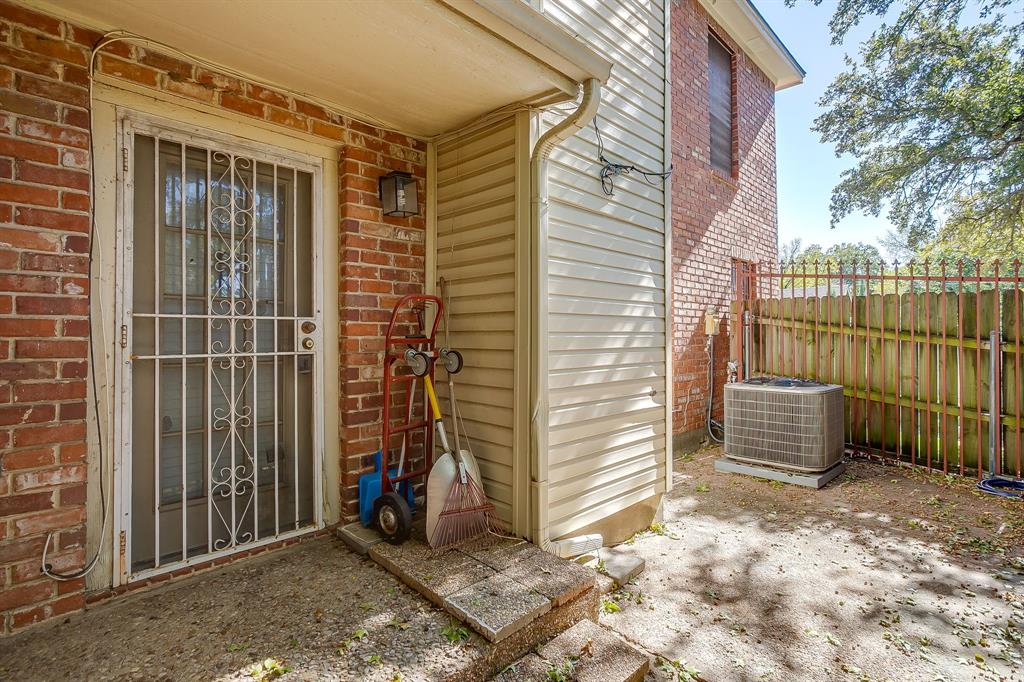 3133 Sappington Place, Unit D Fort Worth, TX 76116 - Photo 24 of 28 a view of a house with a door and wooden fence