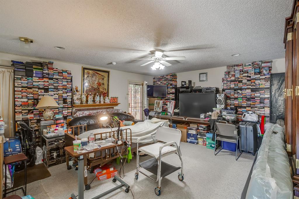 3133 Sappington Place, Unit D Fort Worth, TX 76116 - Photo 3 of 28 a room with lots of furniture and clutter