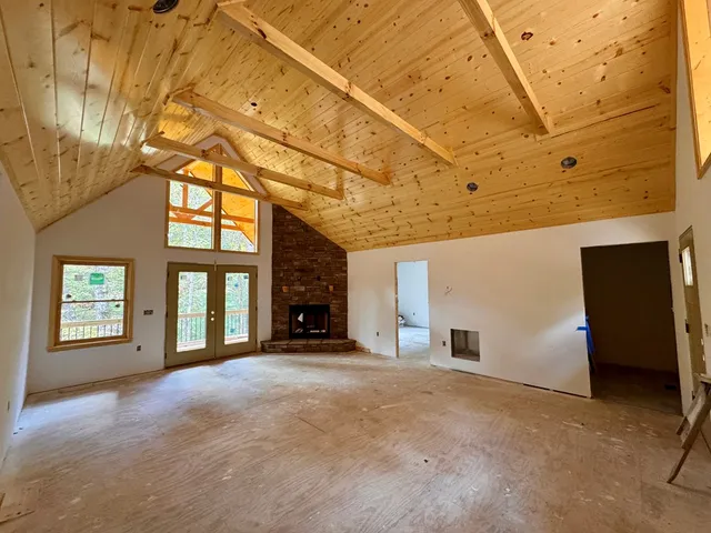 a view of a livingroom with a fireplace and a window