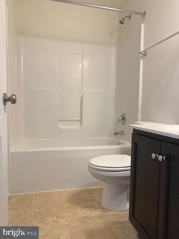 a bathroom with a toilet a sink and bathtub
