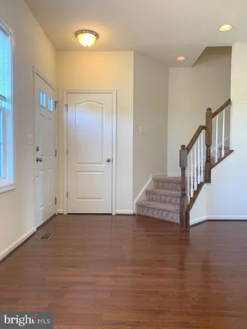 a view of an entryway with wooden floor