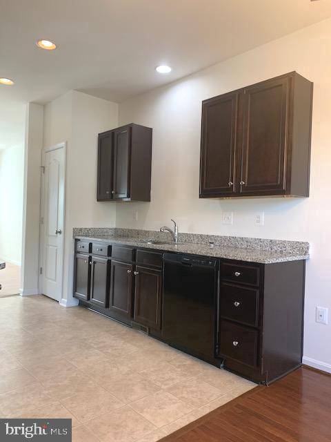 17275 Library Boulevard Ruther Glen, VA 22546 - Photo 5 of 18 a kitchen with stainless steel appliances granite countertop a stove a sink and a microwave
