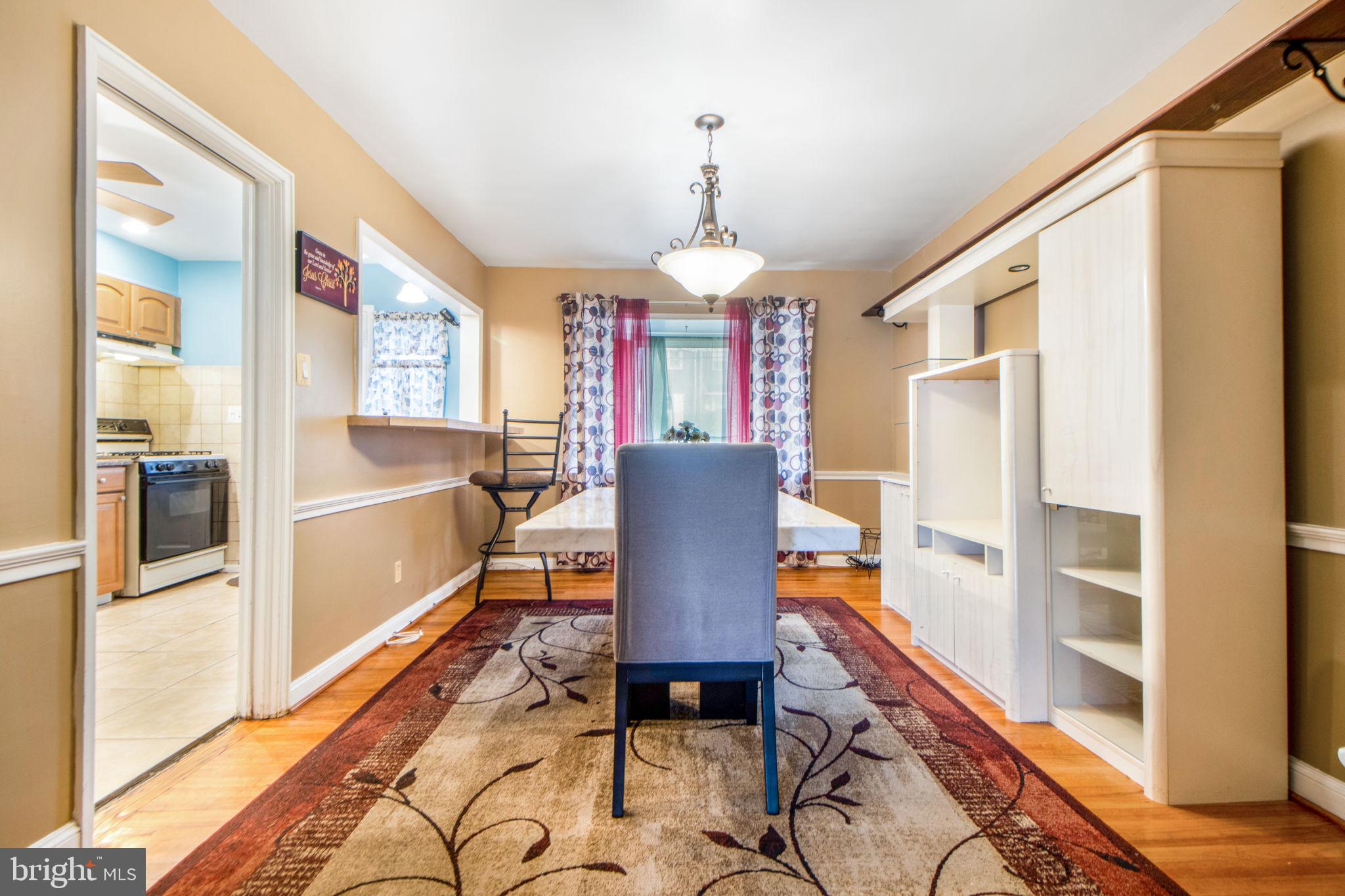 1903 Heathfield Road Baltimore, MD 21239 - Photo 7 of 30 a dining room with furniture a chandelier and wooden floor