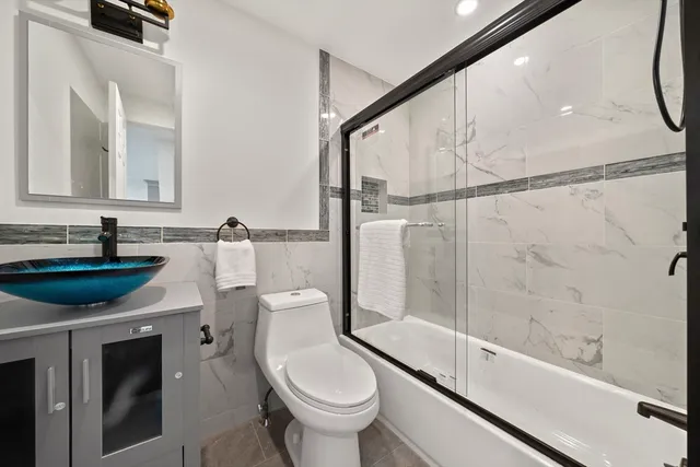 a bathroom with a sink a toilet and a mirror