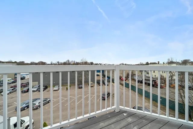 a view of a balcony with wooden floor and fence