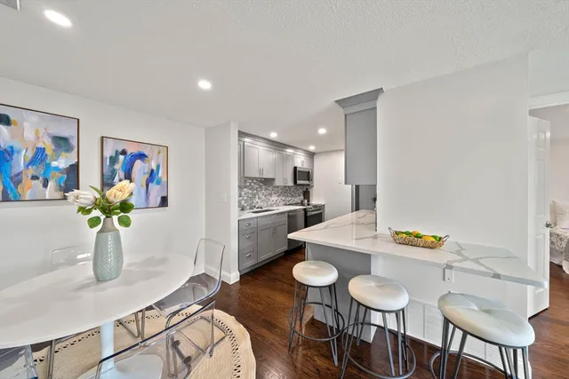 a dining room with furniture and a kitchen view