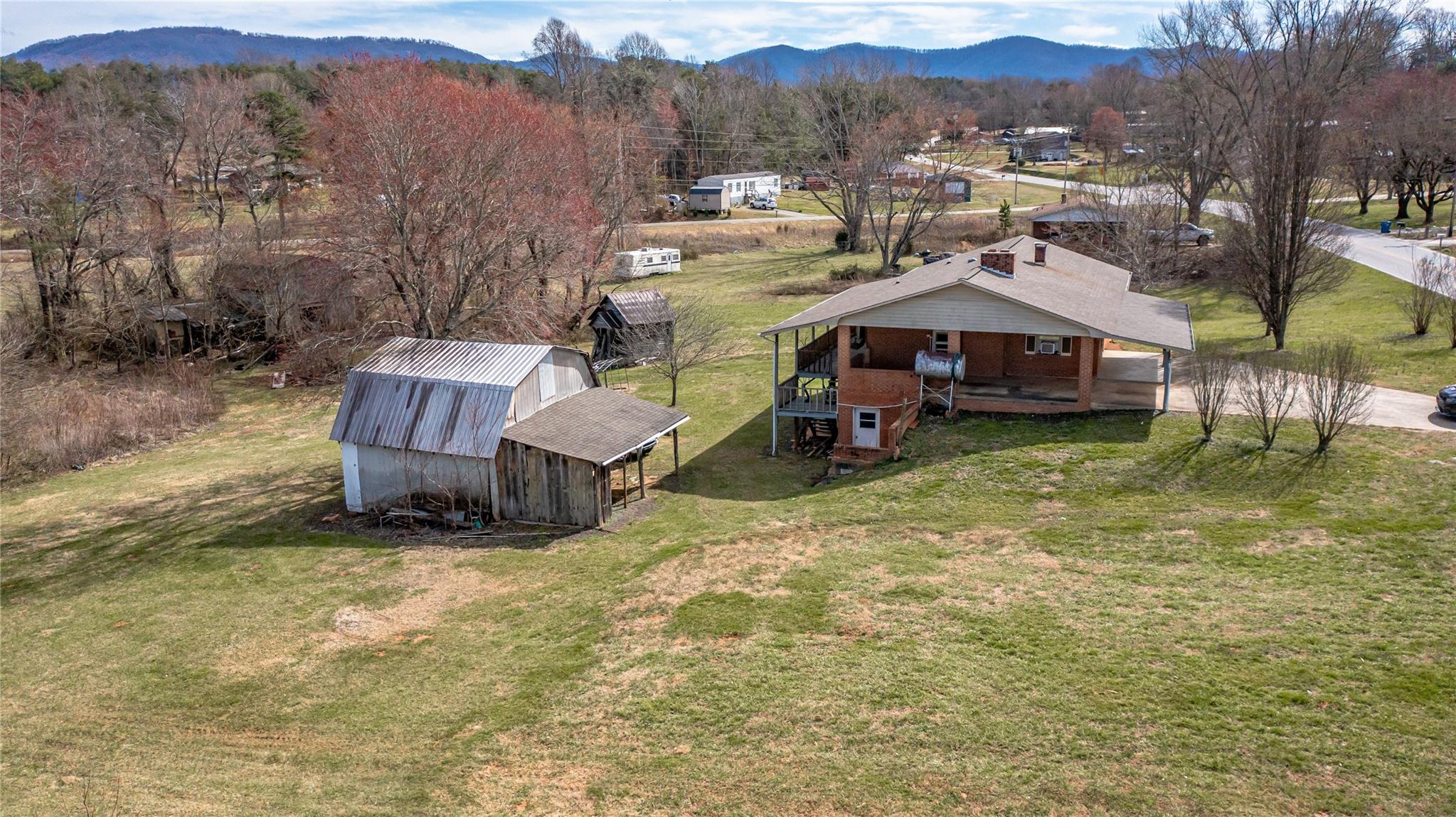1437 Conley Road Morganton, NC 28655 - Photo 13 of 44 a view of a house with a yard fire pit and a large tree