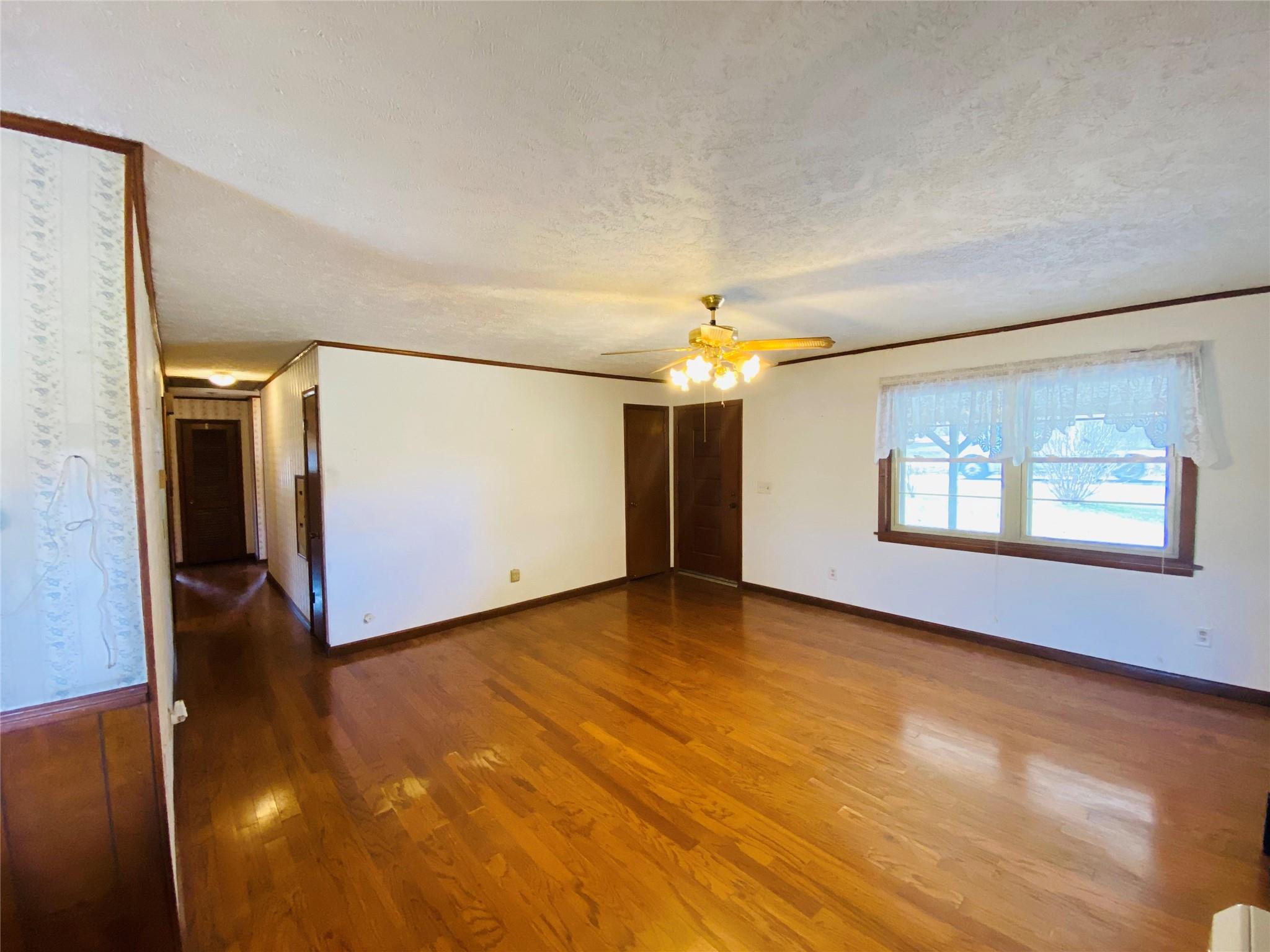 1437 Conley Road Morganton, NC 28655 - Photo 17 of 44 an empty room with wooden floor chandelier and windows