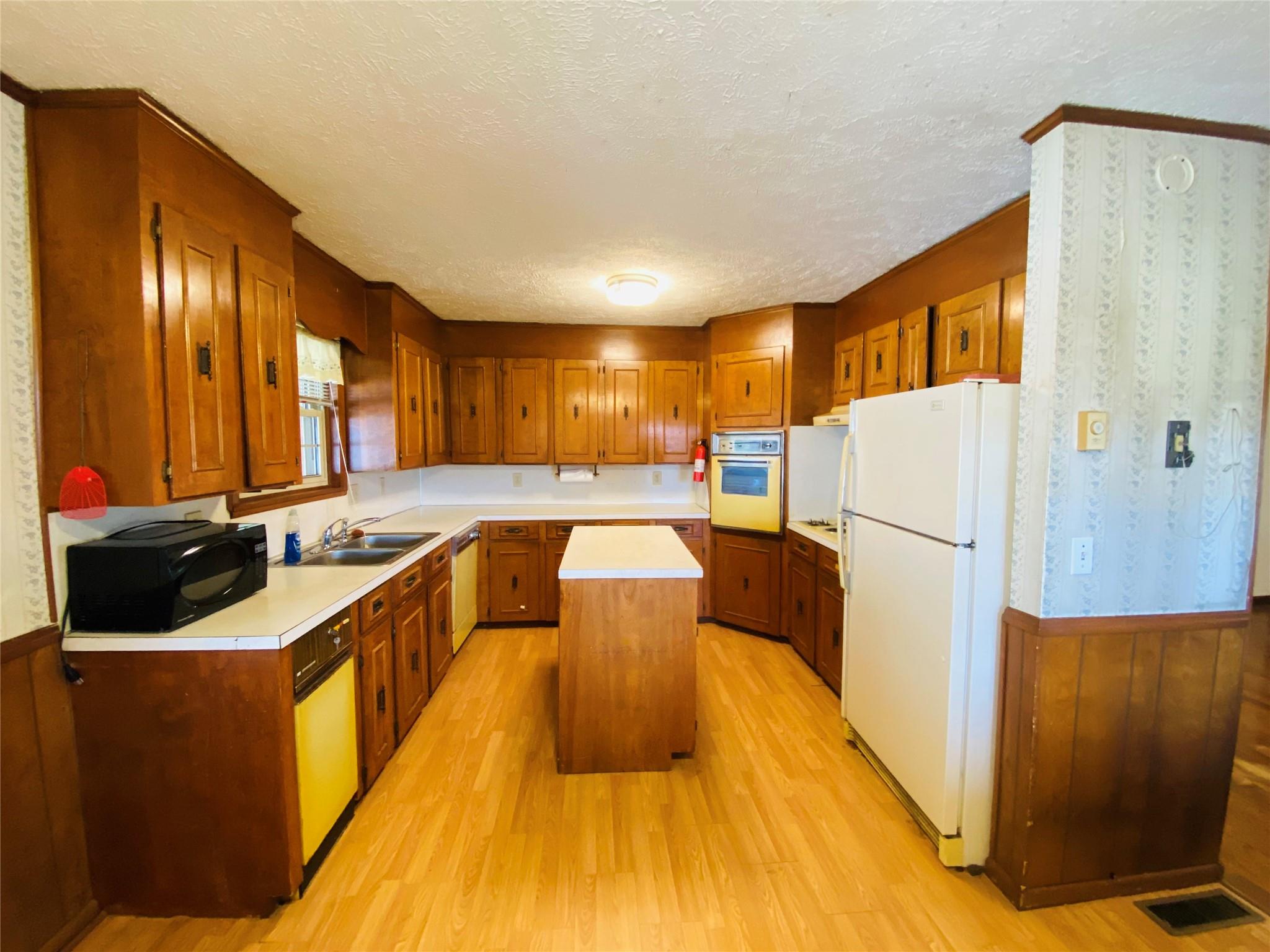 1437 Conley Road Morganton, NC 28655 - Photo 23 of 44 a kitchen with a refrigerator and a sink