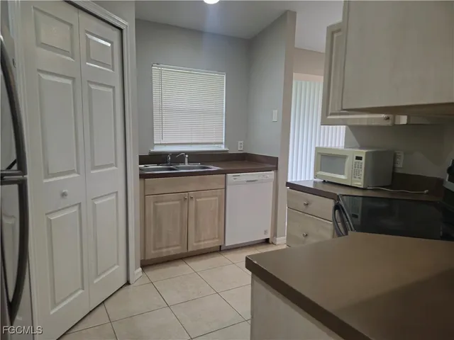 a kitchen with a refrigerator stove and cabinets