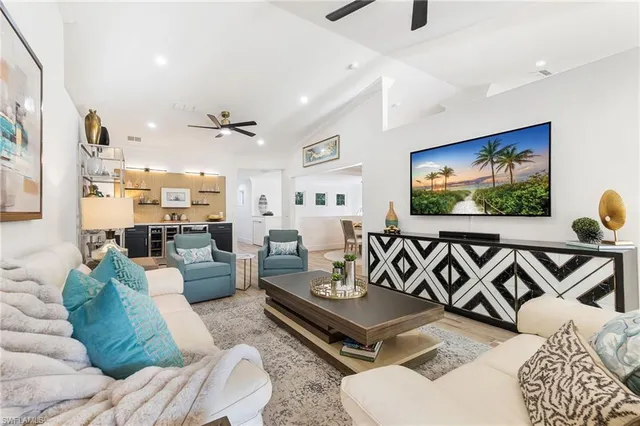 a living room with furniture a rug and a flat screen tv