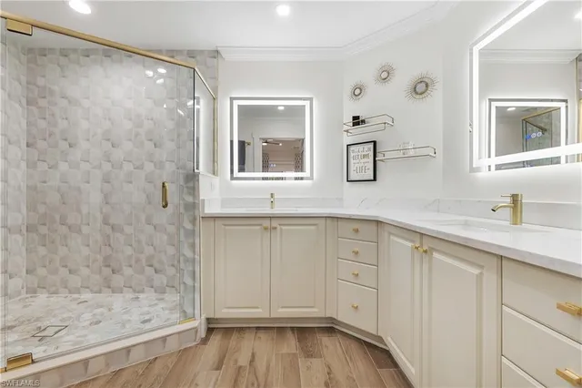 a bathroom with a granite countertop sink mirror and shower
