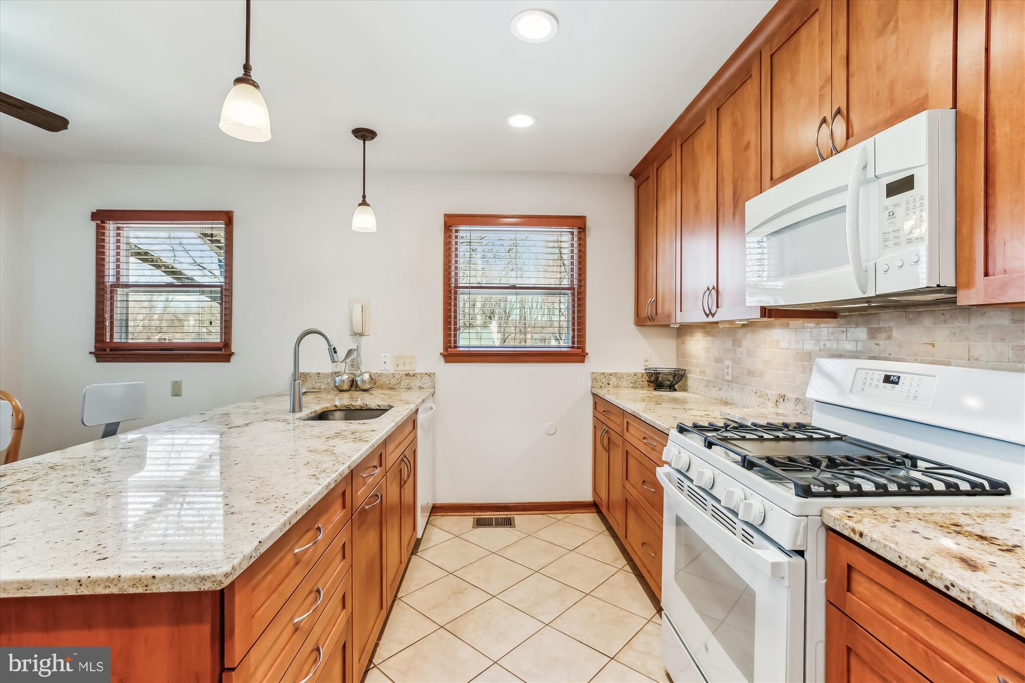 1711 Cody Drive Silver Spring, MD 20902 - Photo 15 of 50 a kitchen with granite countertop a sink stove and cabinets