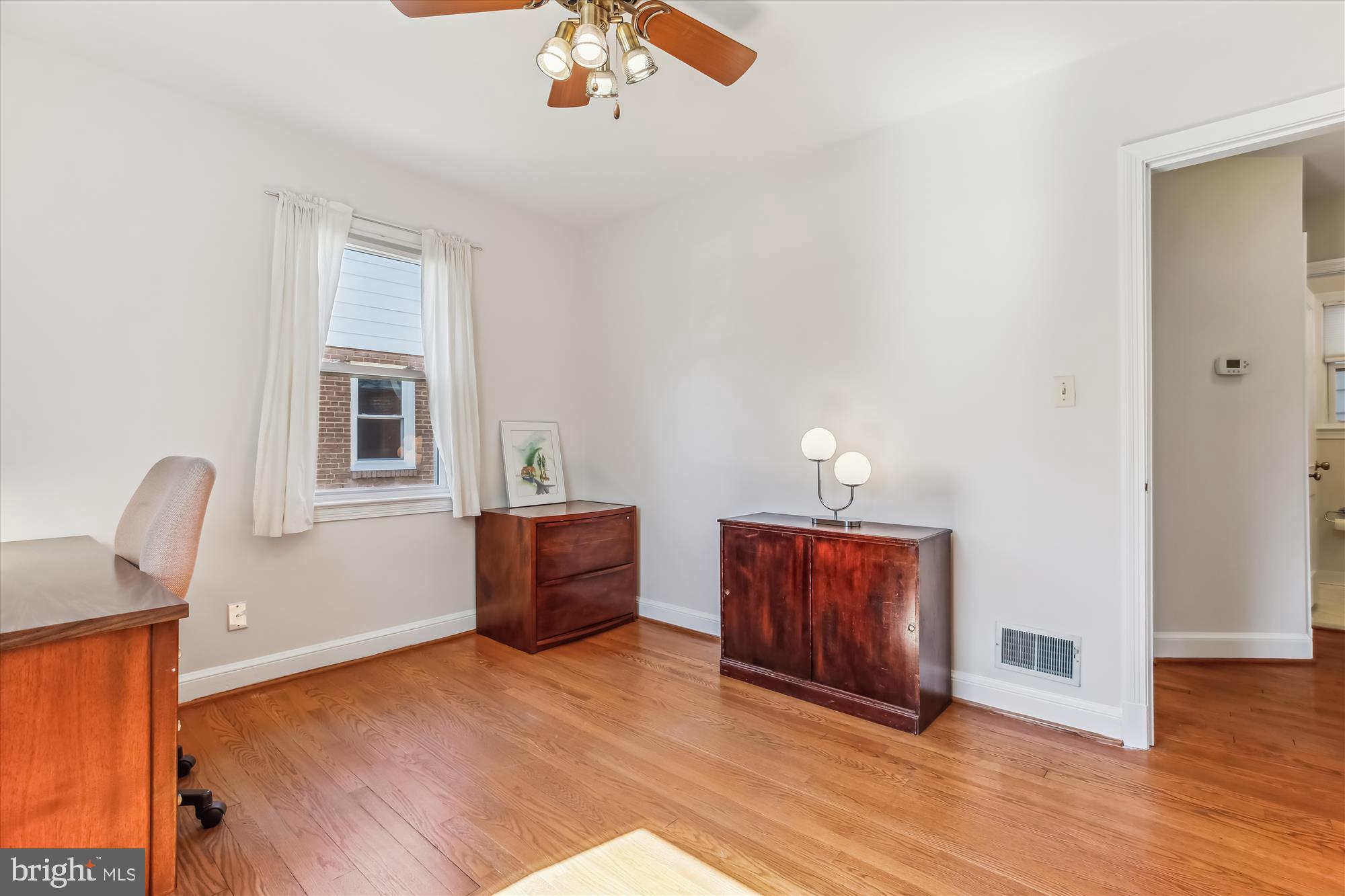 1711 Cody Drive Silver Spring, MD 20902 - Photo 28 of 50 a room with furniture and wooden floor