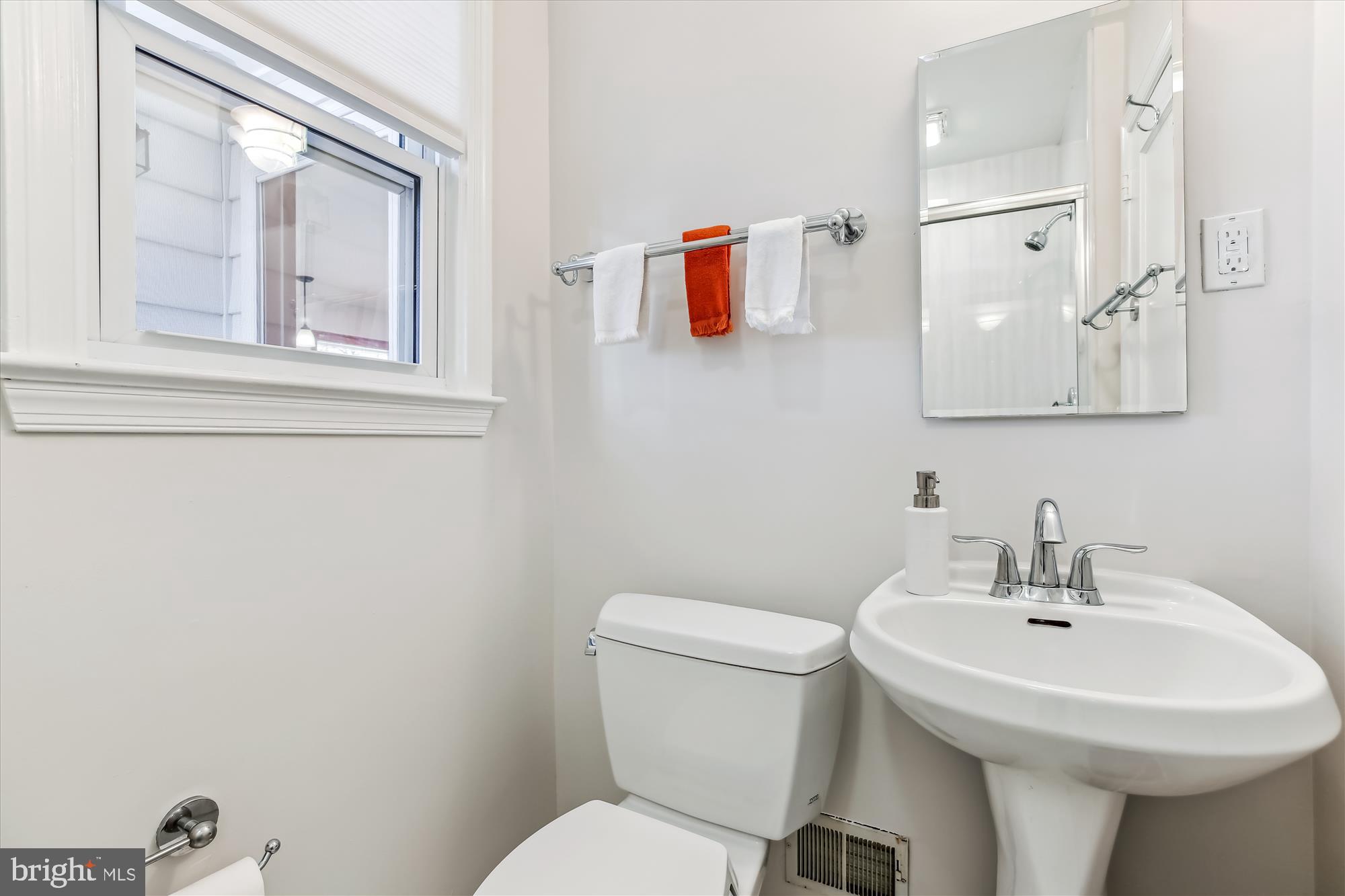 1711 Cody Drive Silver Spring, MD 20902 - Photo 32 of 50 a bathroom with a toilet sink and mirror