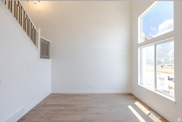 5228 South Acacia Drive, Unit 808 Mapleton, UT 84664 - Photo 5 of 22 Two-story entry featuring high ceilings, contemporary black metal stair railing, light wood-finish flooring, and expansive windows