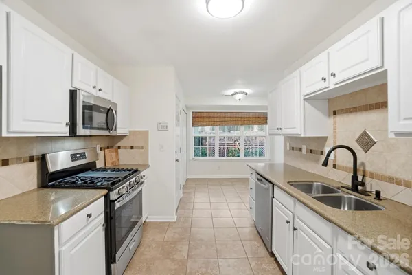 a kitchen that has a sink and a stove