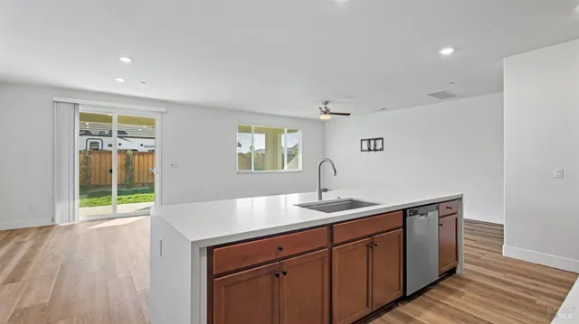 a kitchen with granite countertop kitchen island a sink appliances and a counter space