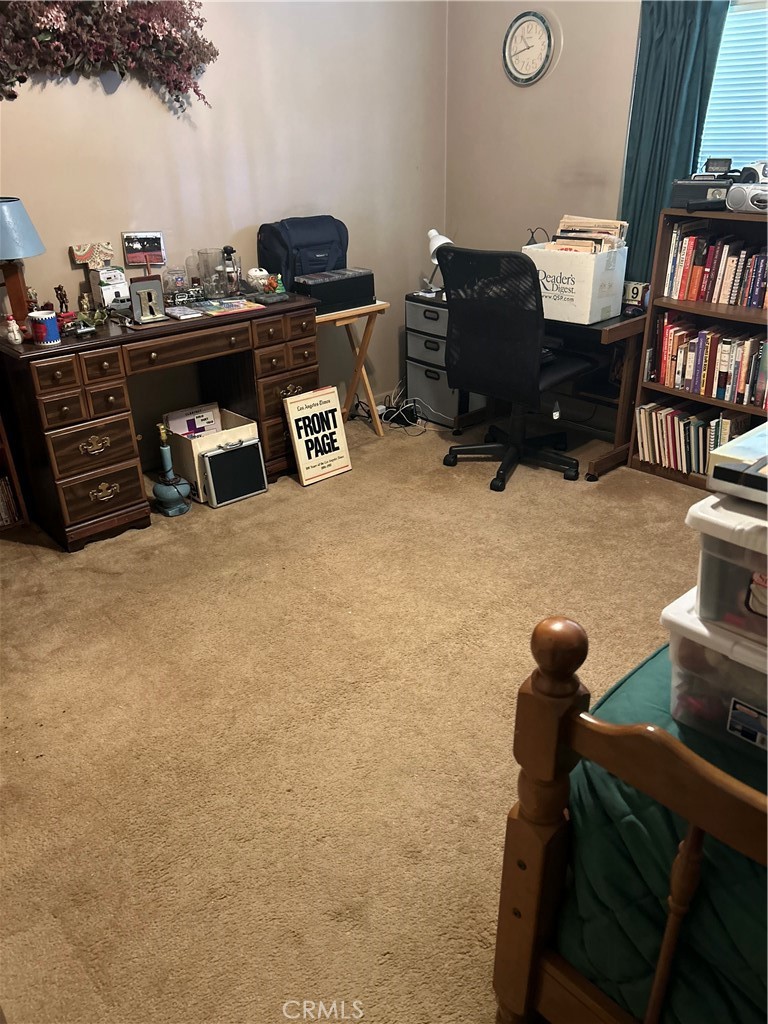 6460 Dos Rios Road Downey, CA 90240 - Photo 11 of 34 a living room with furniture and a book shelf