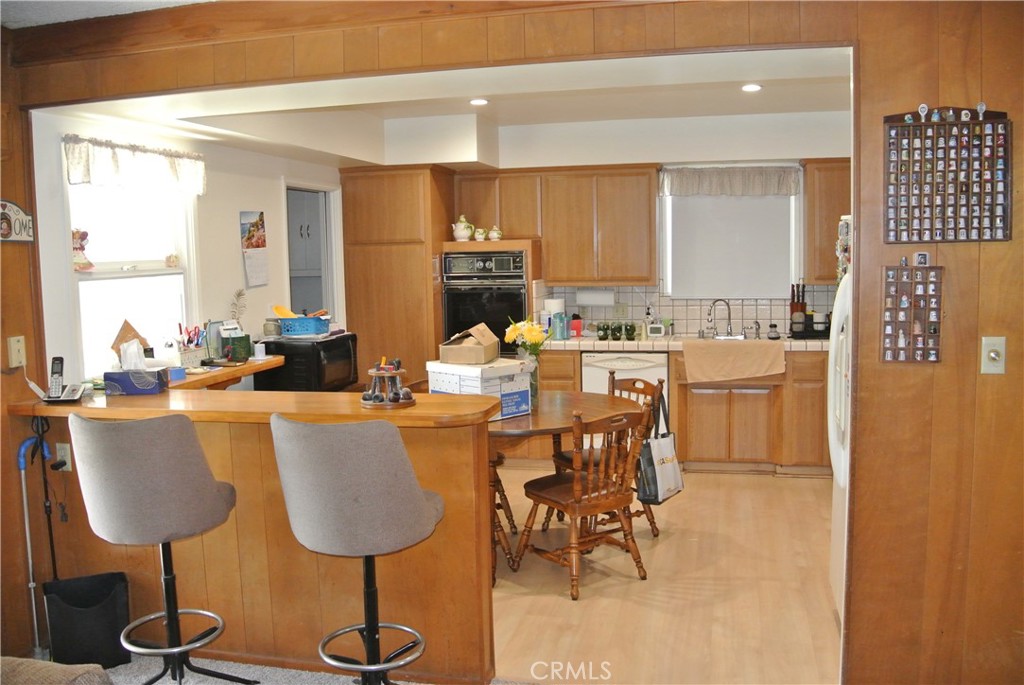 6460 Dos Rios Road Downey, CA 90240 - Photo 12 of 34 a dining room with furniture a window and a glass door