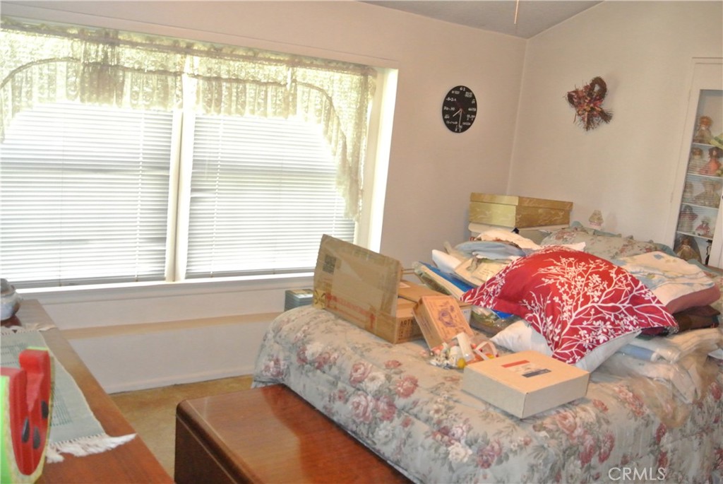 6460 Dos Rios Road Downey, CA 90240 - Photo 15 of 34 a bedroom with a bed and a window