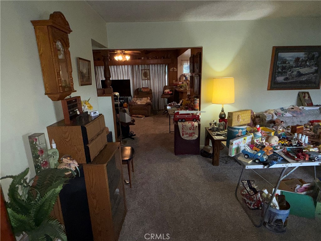 6460 Dos Rios Road Downey, CA 90240 - Photo 16 of 34 a view of a livingroom with furniture and a ceiling fan