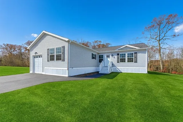 a front view of house with yard and green space