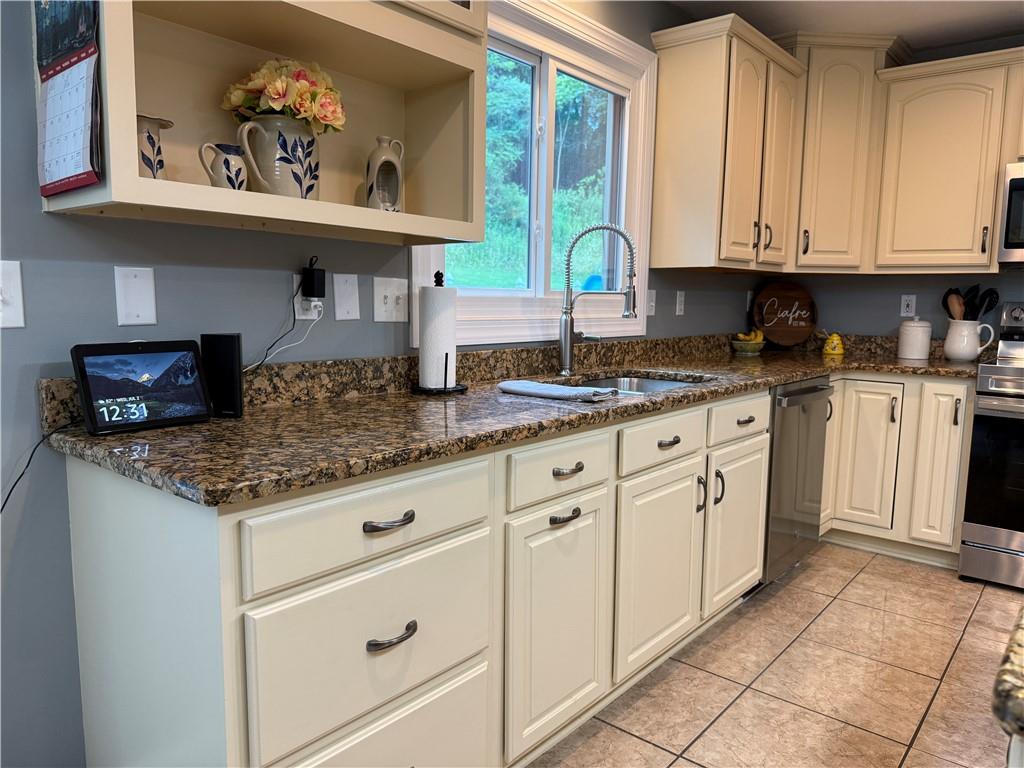 293 Sandy Hill Road Valencia, PA 16059 - Photo 28 of 50 a kitchen with stainless steel appliances granite countertop a sink and cabinets