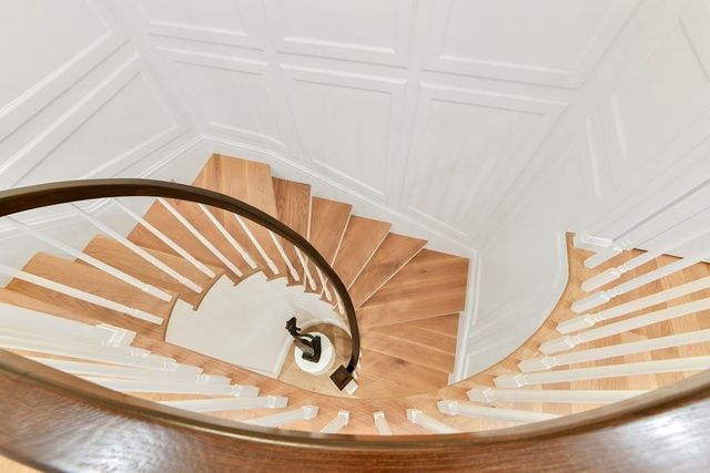 a view of a room with stairs and wooden floor