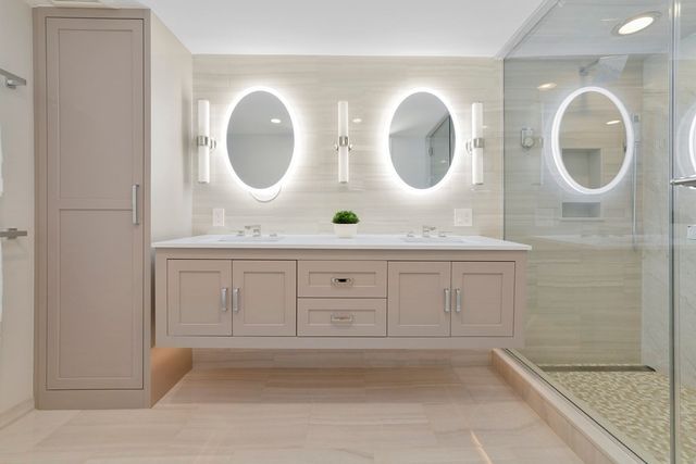 a bathroom with a double vanity sink and a mirror
