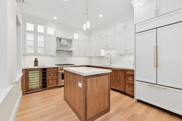 a kitchen with stainless steel appliances granite countertop a sink stove and refrigerator