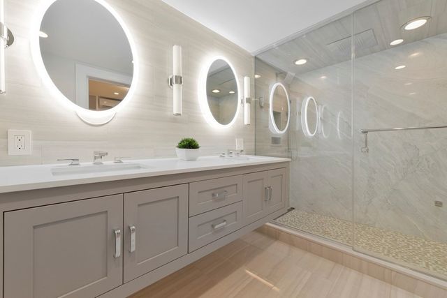 a spacious bathroom with a double vanity sink and a mirror