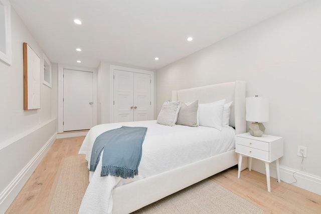 a spacious bedroom with a bed and a cabinets