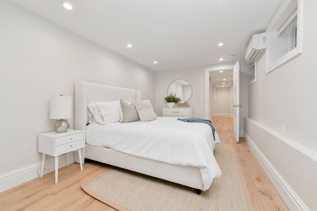 a spacious bedroom with a bed and a cabinets