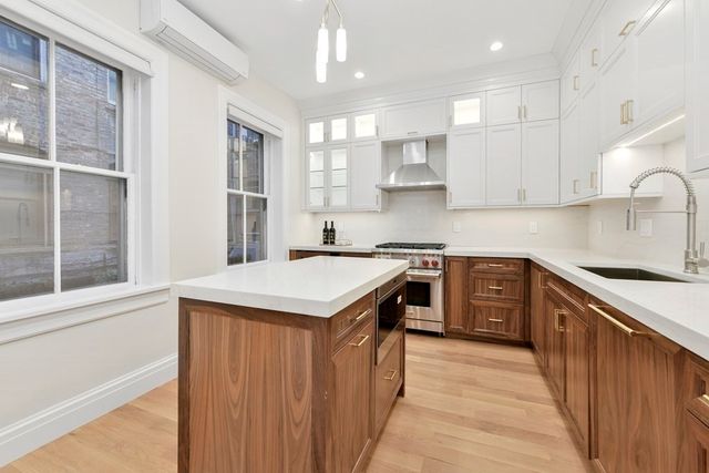 a kitchen with a stove a sink and a refrigerator